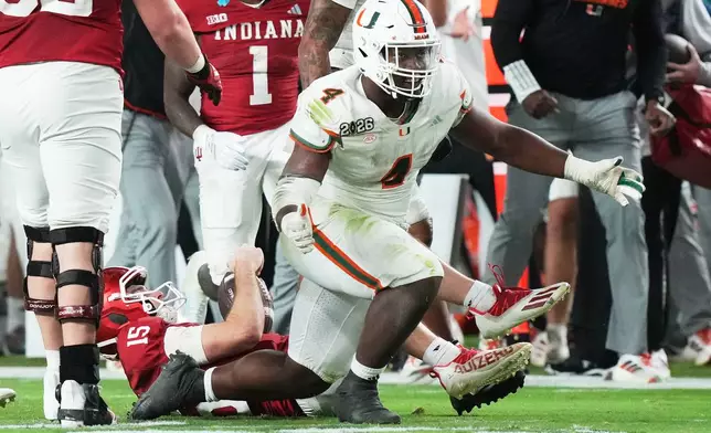 Indiana quarterback Fernando Mendoza is sacked by Miami defensive lineman Rueben Bain Jr. during the second half of the College Football Playoff national championship game, Monday, Jan. 19, 2026, in Miami Gardens, Fla.(AP Photo/Marta Lavandier)