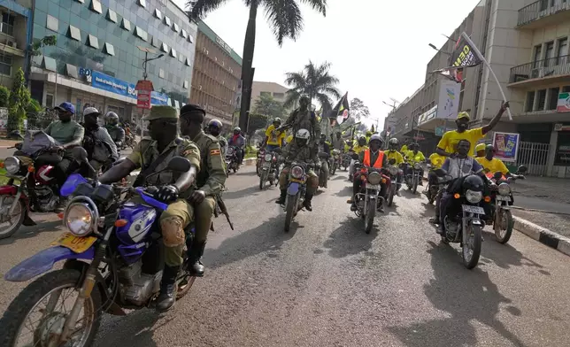 Uganda's security forces patrol a street as supporters of Ugandan President Yoweri Museveni celebrate his victory in the presidential election in Kampala, Uganda, Saturday, Jan. 17, 2026. (AP Photo/Brian Inganga)