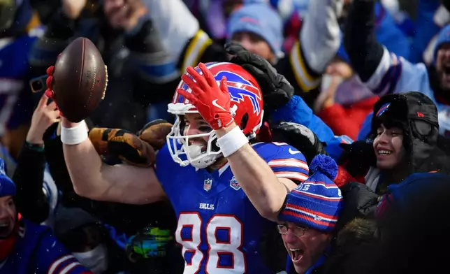 Buffalo Bills tight end Dawson Knox (88) celebrates after scoring a touchdown against the New York Jets in the first half of an NFL football game Sunday, Jan. 4, 2026, in Orchard Park, N.Y. (AP Photo/Adrian Kraus)