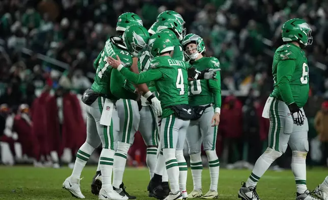 Philadelphia Eagles place kicker Jake Elliott (4) celebrates with teammates after scoring a field goal during the second half of an NFL football game against the Washington Commanders on Sunday, Jan. 4, 2026, in Philadelphia. (AP Photo/Matt Slocum)