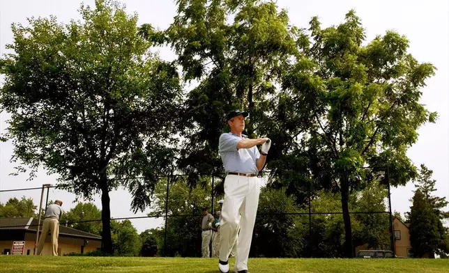 FILE - President George W. Bush practices his swing as he prepares to tee off on the first hole at the golf course at Andrews Air Force Base, Md., July 3, 2002. (AP Photo/Pablo Martinez Monsivais, File)