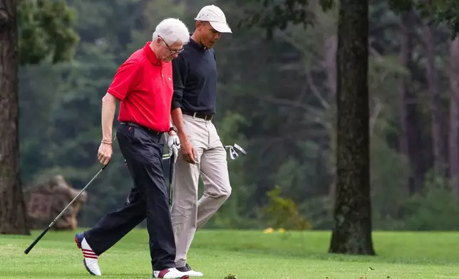 FILE - President Barack Obama, right, talks with former President Bill Clinton while playing a round of golf at Andrews Air Force Base Sept. 24, 2011, at Andrews Air Force Base, Md. (AP Photo/Evan Vucci, File)