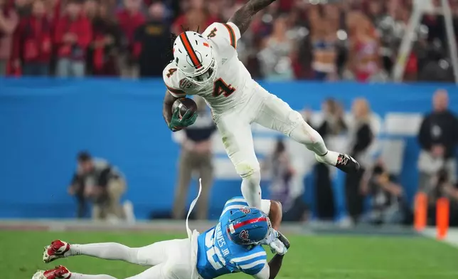 Mississippi cornerback Chris Graves Jr. (32) tackles Miami running back Mark Fletcher Jr. (4) during the first half of the Fiesta Bowl NCAA college football playoff semifinal game, Thursday, Jan. 8, 2026, in Glendale, Ariz. (AP Photo/Ross D. Franklin)