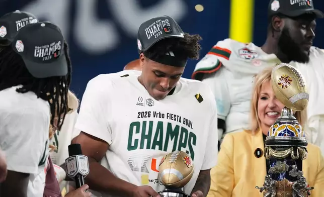 Miami defensive back Jakobe Thomas holds the defensive player of the game trophy after the Fiesta Bowl NCAA college football playoff semifinal game against Mississippi, Thursday, Jan. 8, 2026, in Glendale, Ariz. (AP Photo/Ross D. Franklin)