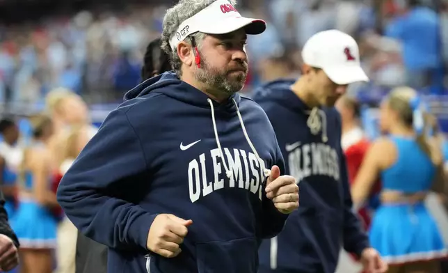 Mississippi head coach Pete Golding runs on the field at halftime during the Sugar Bowl NCAA college football playoff quarterfinal game against Georgia, Thursday, Jan. 1, 2026, in New Orleans. (AP Photo/Matthew Hinton)
