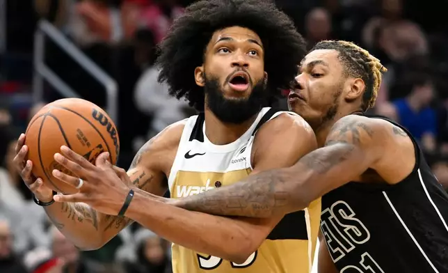 Washington Wizards forward Marvin Bagley III, left, is found by Brooklyn Nets forward Noah Clowney during the first half of an NBA basketball game, Friday, Jan. 2, 2026, in Washington. (AP Photo/John McDonnell)