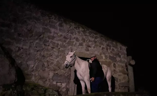 A horse is prepared to take part in a ritual in honor of Saint Anthony the Abbot, the patron saint of domestic animals, in San Bartolome de Pinares, Spain, Friday, Jan. 16, 2026. (AP Photo/Manu Fernandez)
