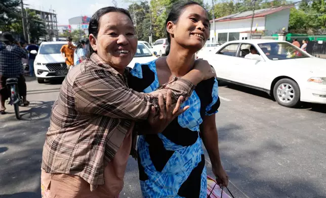 A released prisoner, right, is welcomed by her colleague after she was released from Insein Prison Sunday, Jan. 4, 2026, in Yangon, Myanmar. (AP Photo/Thein Zaw)
