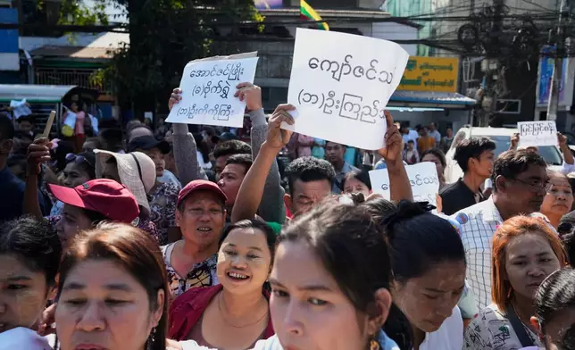 Family members and colleagues wait to welcome the released prisoners from Insein Prison Sunday, Jan. 4, 2026, in Yangon, Myanmar. (AP Photo/Thein Zaw)