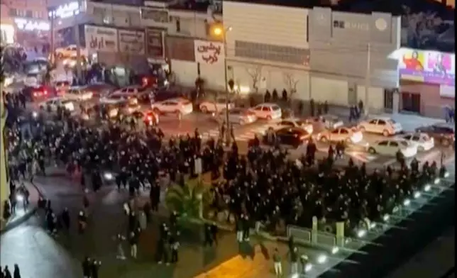 In this frame grab from video taken by an individual not employed by The Associated Press and obtained by the AP outside Iran shows people blocking an intersection during a protest in Tehran, Iran, Thursday Jan. 8, 2026. (UGC via AP)