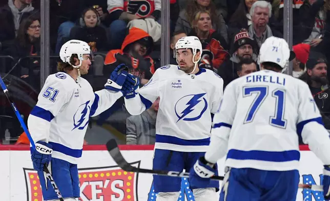 Tampa Bay Lightning's Nick Paul, center, celebrates after his goal with Charle-Edouard D'Astous (51) during the second period of an NHL hockey game against the Philadelphia Flyers, Saturday, Jan. 10, 2026, in Philadelphia. (AP Photo/Derik Hamilton)