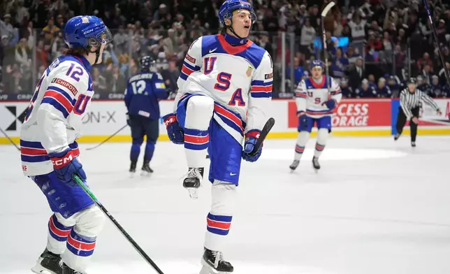 United States forward Ryker Lee, front right, celebrates after scoring during the third period of an IIHF World Junior Hockey Championship quarterfinals game against Finland, Friday, Jan. 2, 2026, in St. Paul, Minn. (AP Photo/Abbie Parr)