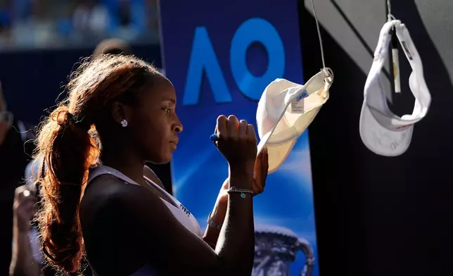 Coco Gauff of the U.S. signs autographs after defeating Karolina Muchova of the Czech Republic in their fourth round match at the Australian Open tennis championship in Melbourne, Australia, Sunday, Jan. 25, 2026. (AP Photo/Asanka Brendon Ratnayake)