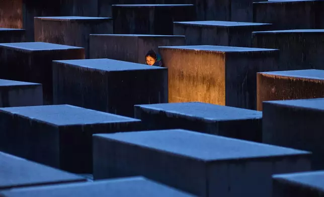 A woman from Hong Kong visits the Holocaust memorial on the eve of the International Holocaust Memorial Day in Berlin, Germany, Monday, Jan. 26, 2026. (AP Photo/Markus Schreiber)