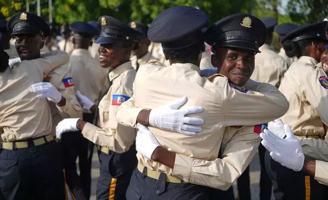 New members of the National Police force celebrate after their graduation ceremony at the Police Academy in Port-au-Prince, Haiti, Friday, Jan. 23, 2026. (AP Photo/Odelyn Joseph)