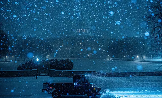 A plow clears snow in front of the U.S. Capitol, Sunday, Jan. 25, 2026, in Washington. (AP Photo/Julia Demaree Nikhinson)