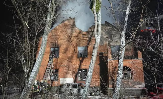 Rescue workers put out a fire at a residential building damaged by a Russian strike in Kyiv, Ukraine, Friday, Jan. 9, 2026. (AP Photo/Efrem Lukatsky)