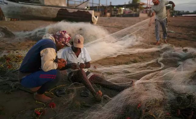 Fishermen ready their nets near the Cardon refinery in Punta Cardon, Venezuela, Wednesday, Jan. 14, 2026. (AP Photo/Matias Delacroix)
