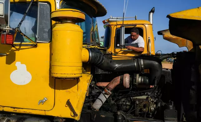 Truck driver Francisco Rodriguez waits to load salt at the Salinas de Cumaraguas salt flats on the Paraguana Peninsula, Venezuela, Thursday, Jan. 15, 2026. (AP Photo/Matias Delacroix)