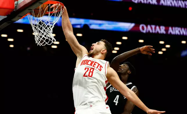 Houston Rockets center Alperen Sengun (28) dunks against Brooklyn Nets guard Drake Powell (4) during the first half of an NBA basketball game, Thursday, Jan. 1, 2026, in New York. (AP Photo/Noah K. Murray)
