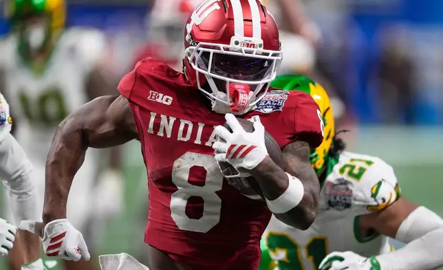 Indiana running back Kaelon Black (8) carries for a touchdown against Oregon during the second half of the Peach Bowl NCAA college football playoff semifinal, Friday, Jan. 9, 2026, in Atlanta. (AP Photo/Mike Stewart)