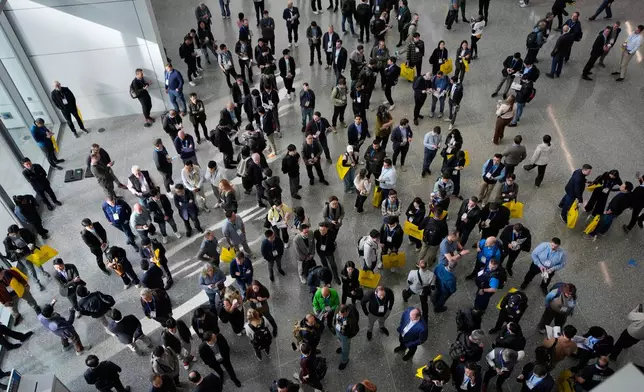People wait for the opening of the CES tech show Tuesday, Jan. 6, 2026, in Las Vegas. (AP Photo/John Locher)