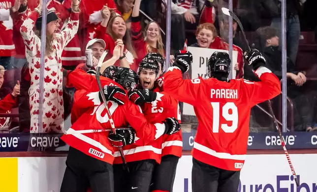 Canada's Cole Beaudoin (26) celebrates his goal with teammates after scoring in second period IIHF World Junior Championship hockey action against Finland in Minneapolis on Wednesday, Dec. 31, 2025. (Christopher Katsarov/The Canadian Press via AP)