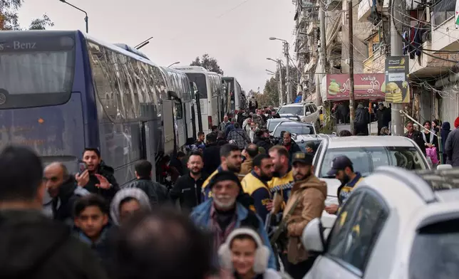 Displaced residents return to the Sheikh Maqsoud neighborhood after days of fighting between government forces and Kurdish fighters in the northern city of Aleppo, Syria, Tuesday, Jan. 13, 2026. (AP Photo/Ghaith Alsayed)