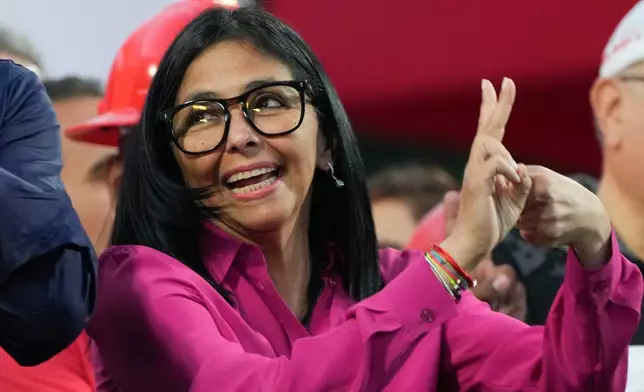 Venezuela's acting President Delcy Rodriguez flashes a vee hand sign while greeting oil workers and government supporters at the Miraflores Palace during a rally backing an oil reform bill to loosen state control and open the industry to private and foreign investment in Caracas, Venezuela, Thursday, Jan. 29, 2026. (AP Photo/Ariana Cubillos)