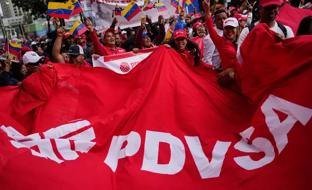 Workers of Venezuela's state-owned PDVSA oil company rally to back an oil reform bill proposed by acting President Delcy Rodriguez to loosen state control and open the industry to private and foreign investment in Caracas, Venezuela, Thursday, Jan. 29, 2026. (AP Photo/Ariana Cubillos)