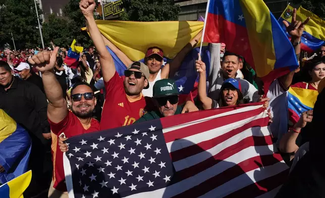 Venezuelans celebrate after U.S. President Donald Trump announced that Venezuelan President Nicolas Maduro had been captured and flown out of the country in Santiago, Chile, Saturday, Jan. 3, 2026. (AP Photo/Esteban Felix)