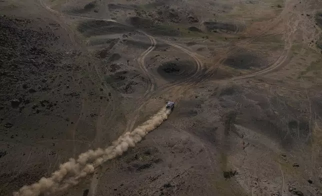 Driver Carlos Sainz and co-driver Lucas Cruz compete during the first stage of the Dakar Rally in Yanbu, Saudi Arabia, Sunday, Jan. 4, 2026. (AP Photo/Thibault Camus)