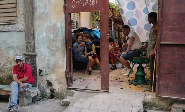 People spend the afternoon in Old Havana, Monday, January 5, 2026. (AP Photo/Ramon Espinosa)