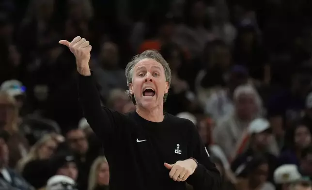 Washington Wizards head coach Brian Keefe shouts instructions to his players during the first half of an NBA basketball game against the Phoenix Suns, Sunday, Jan. 11, 2026, in Phoenix. (AP Photo/Ross D. Franklin)