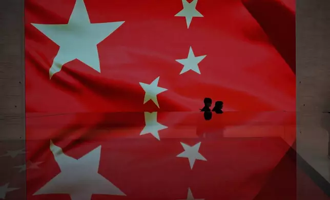 Visitors attend an exhibition on the Chinese national flag at the National Museum in Beijing, China, Wednesday, Jan. 21, 2026. (AP Photo/Ng Han Guan)