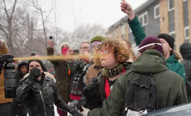 Federal agents use a chemical agent on an person on Wednesday, Jan. 21, 2026, in Minneapolis. (AP Photo/Angelina Katsanis)