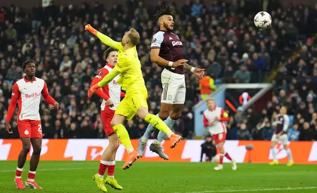 Aston Villa's Tyrone Mings, top, scores during the Europa League opening phase soccer match between Aston Villa and RB Salzburg in Birmingham, England, Thursday Jan. 29, 2026. (Martin Rickett/PA via AP)