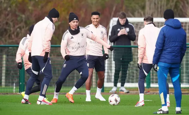 Aston Villa's Morgan Rogers, centre left, Pau Torres, second left, and Ollie Watkins, centre, practice during a training session in Tamworth, England, Wednesday Jan. 28, 2026, one day ahead of their Europa League soccer match against Salzburg. (David Davies/PA via AP)