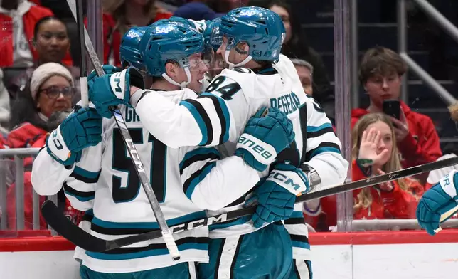 San Jose Sharks right wing Collin Graf (51) celebrates his goal with left wing Pavol Regenda (84) and others during the second period of an NHL hockey game against the Washington Capitals, Thursday, Jan. 15, 2026, in Washington. (AP Photo/Nick Wass)