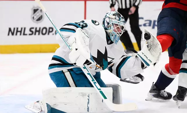 San Jose Sharks goaltender Alex Nedeljkovic (33) stops the puck during the first period of an NHL hockey game against the Washington Capitals, Thursday, Jan. 15, 2026, in Washington. (AP Photo/Nick Wass)