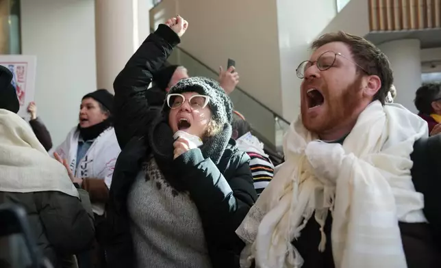 Protesters against Federal immigration agents gather at Target, Friday, Jan. 23, 2026, in Minneapolis. (AP Photo/Abbie Parr)