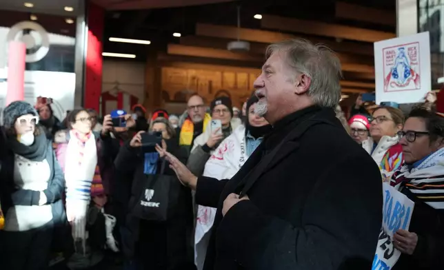 Paster Grant Stevenson joins other protesters against Federal immigration agents Target, Friday, Jan. 23, 2026, in Minneapolis. (AP Photo/Abbie Parr)