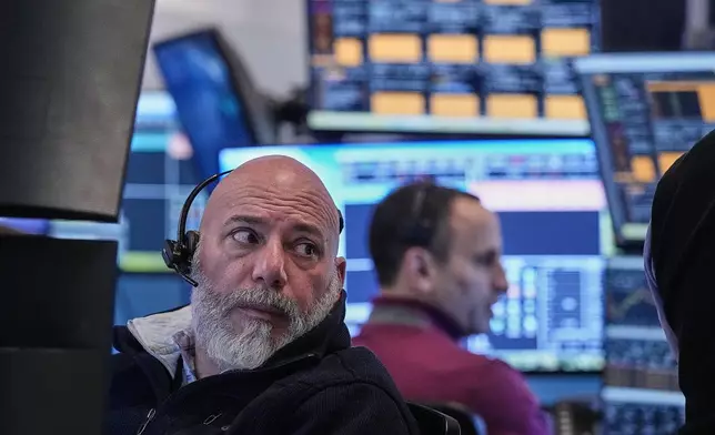 Trader Vincent Napolitano, left, on the floor of the New York Stock Exchange, Tuesday, Jan. 20, 2026. (AP Photo/Richard Drew)