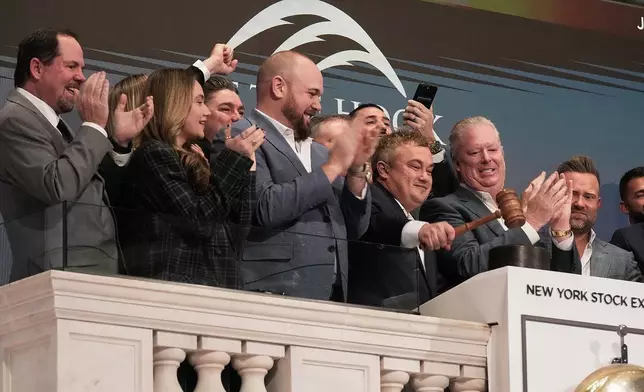 Off The Hook Yachts President Jason Ruegg gavels trading closed at the New York Stock Exchange, Tuesday, Jan. 20, 2026. (AP Photo/Richard Drew)