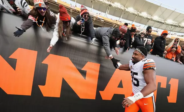 Cleveland Browns defensive end Myles Garrett, bottom, celebrates with fans after an NFL football game against the Cincinnati Bengals, Sunday, Jan. 4, 2026, in Cincinnati. (AP Photo/Jeff Dean)