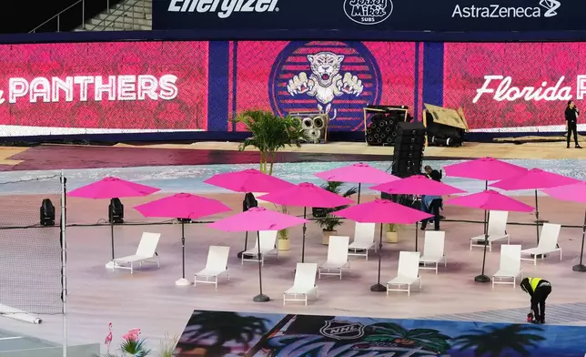 Lounge chairs and umbrellas are shown alongside the ice for the upcoming NHL Winter Classic hockey game between the Florida Panthers and New York Rangers, Tuesday, Dec. 30, 2025, at loanDepot Park in Miami. (AP Photo/Lynne Sladky)