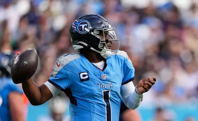 Tennessee Titans quarterback Cam Ward (1) passes against the New Orleans Saints in the first half of an NFL football game, Sunday, Dec. 28, 2025, in Nashville, Tenn. (AP Photo/George Walker IV)