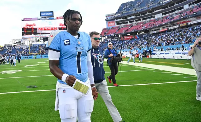 Tennessee Titans quarterback Cam Ward (1) walks off the field after an NFL football game against the New Orleans Saints, Sunday, Dec. 28, 2025, in Nashville, Tenn. (AP Photo/John Amis)