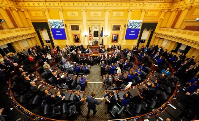 Virginia Gov. Glenn Youngkin, center, arrives to deliver his State of the Commonwealth Address during the opening of the 2026 session of the General Assembly at the Capitol in Richmond, Va., Wednesday Jan. 14, 2026. (AP Photo/Steve Helber)