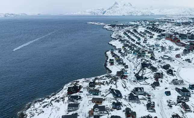 Houses are seen near the coast of a sea inlet of Nuuk, Greenland, on Saturday, Jan. 24, 2026. (AP Photo/Evgeniy Maloletka)